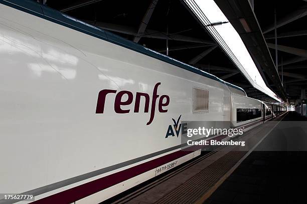 An Alta Velocidad Espanola high-speed train operated by Renfe Operadora SC sits alongside a platform at Joaquin Sorolla railway station in Valencia,...