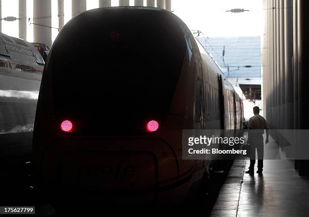 Lights sit illuminated on the front of train operated by Renfe Operadora SC at a platform of Atocha train station in Madrid, Spain, on Saturday, Aug....