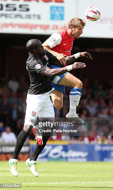 Richard Cresswell of York City rises above Kevin Amankwaah of Northampton Town to head the ball during the Sky Bet League Two match between York City...