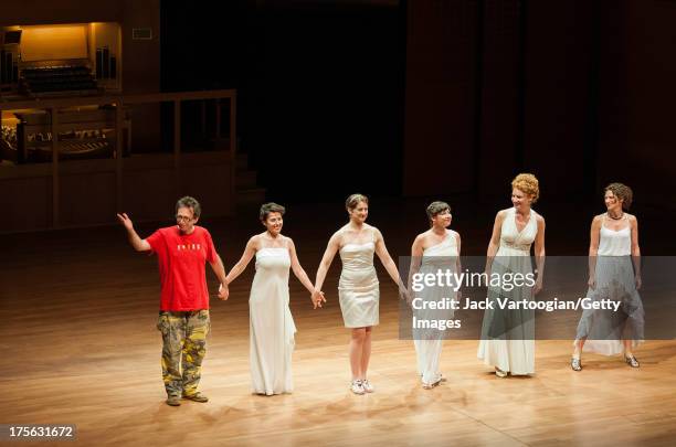 American composer and musician John Zorn takes a bow with singers who had performed his works earlier in the evening, from left, soprano Jane...