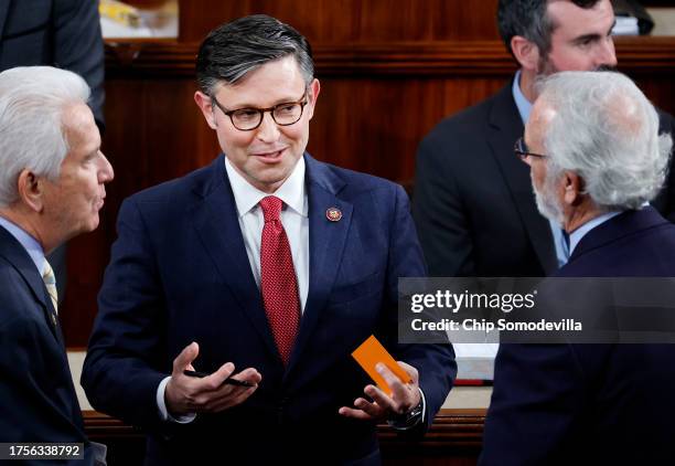Rep. Mike Johnson talks with fellow lawmakers as the House of Representatives holds an election for a new Speaker of the House at the U.S. Capitol on...