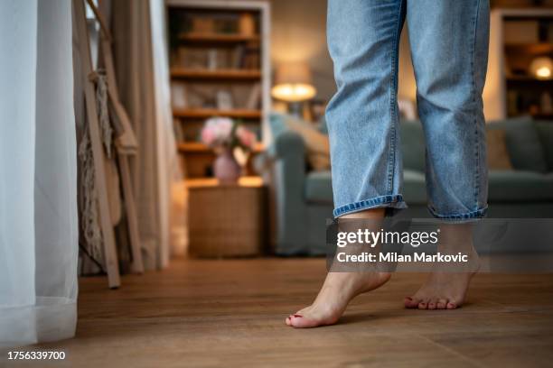 a young woman walks on a warm floor, barefoot - tiptoe stock pictures, royalty-free photos & images