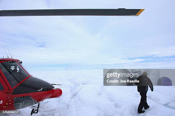 Scientist Ian Joughin of the University of Washington walks across the glacial ice sheet during a research project to study the ice sheet flow on...