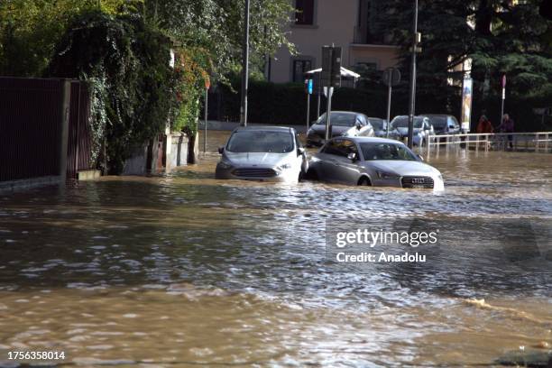 Vehicles wade through floodwaters after the flooding of the Seveso river hit in the northern area of Milan and in the Isola district of the city,...