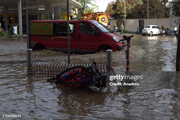 Vehicles wade through floodwaters after the flooding of the Seveso river hit in the northern area of Milan and in the Isola district of the city,...