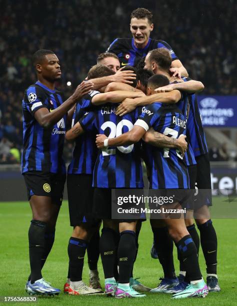 Hakan Calhanoglu of FC Internazionale celebrates with his team-mates after scoring the team's second goal from the penalty spot during the UEFA...