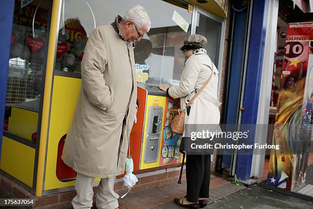 People play on machines outside an amusement arcade on August 5, 2013 in Rhyl, Wales. The think tank The Centre for Social Justice has today said...