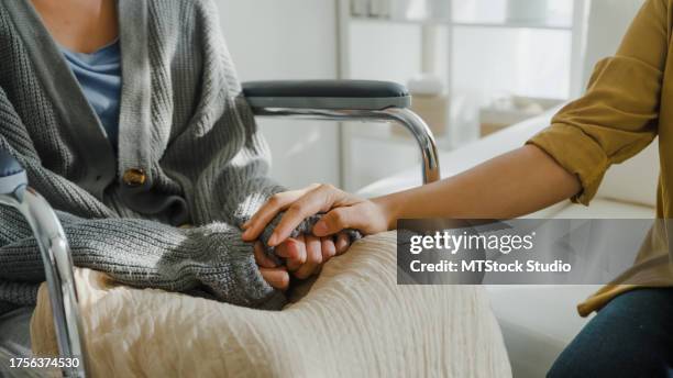 closeup de jovens asiáticos de mãos dadas confiança conforto ajudar pacientes com câncer falar choro alívio do estresse na sala de estar em casa. saúde. - leukemia - fotografias e filmes do acervo