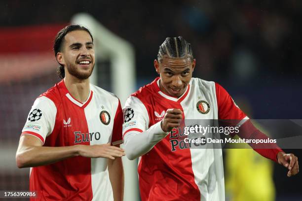 Ramiz Zerrouki of Feyenoord celebrates with teammate Calvin Stengs after scoring the team's second goal during the UEFA Champions League match...