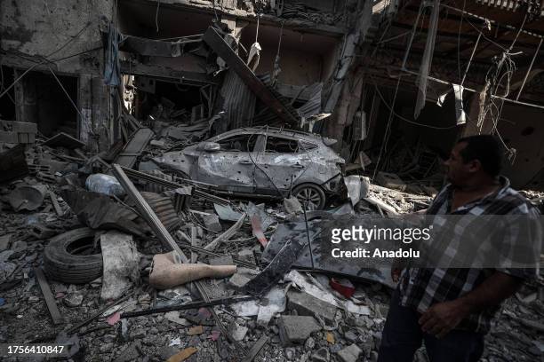 Man passes by the debris of destroyed buildings as Israeli attacks continue at Al-Shati refugee camp of Gaza City, Gaza on October 31, 2023.