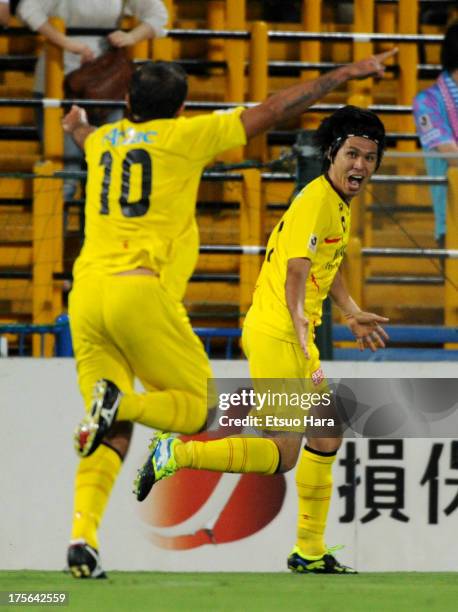 Masato Kudo of Kashiwa Reysol celebrates scoring his team's first goal with his team mate Leandro Domingues during the J.League match between Kashiwa...