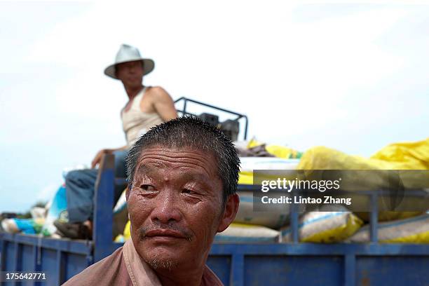 Farmers looks on at Jiejinkou Hoche Township on August 2, 2013 in Tongjiang, Heilongjiang Province, China. Jiejinkou Hoche Township is located in the...