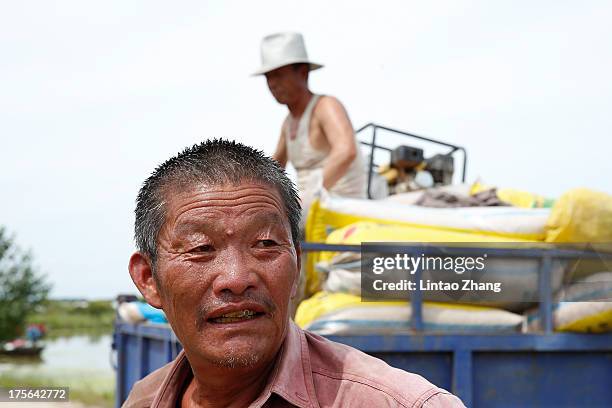 Farmers looks on at Jiejinkou Hoche Township on August 2, 2013 in Tongjiang, Heilongjiang Province, China. Jiejinkou Hoche Township is located in the...