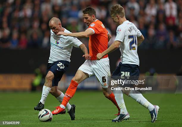 Kirk Broadfoot of Blackpool in action with Iain Hume and William Hayhurst of Preston North End during the Capital One Cup first round match between...