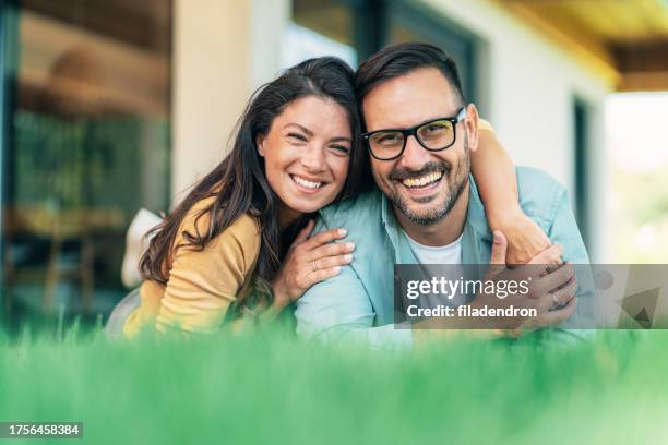 happy couple - eastern european man in front of house stock pictures, royalty-free photos & images