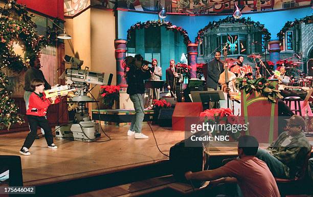 Episode 594 -- Pictured: Child actor Eric Lloyd plays with a water gun on December 22, 1994 --