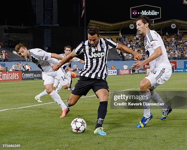 Fabio Quagliarella of Juventus controls the ball against Robbie Rogers and Omar Gonzalez of the Los Angeles Galaxy during the second half of the 2013...