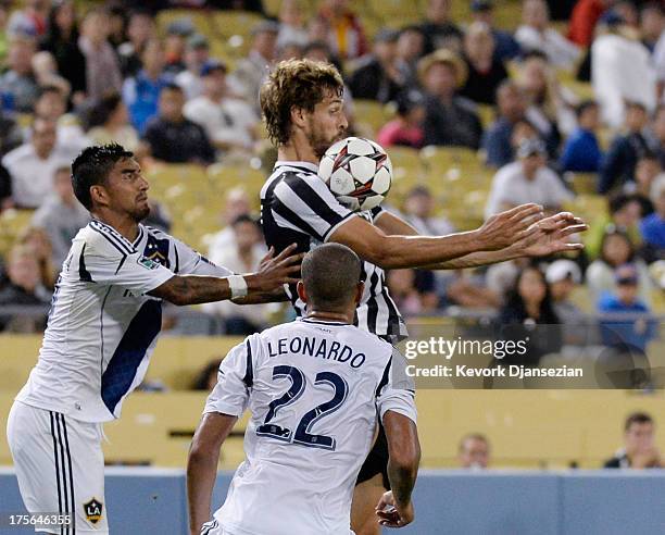 Fernando Llorente of Juventus controls the ball against defenders Leonardo and A.J. De La Garza of the Los Angeles Galaxy during the second half of...