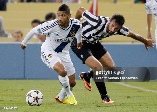 Sean Franklin of Los Angeles Galaxy controls the ball against Mirko Vucinic of Juventus during 2013 Guinness International Champions Cup at Dodger...