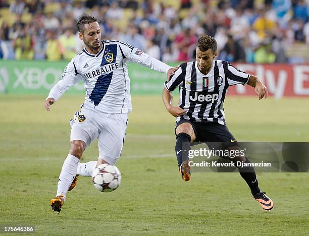 Sebastian Giovinco of Juventus in action against A.J. De La Garza of Los Angeles Galaxy during 2013 Guinness International Champions Cup at Dodger...