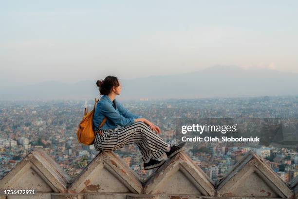 woman sitting overlooking kathmandu cityscape - solo travel stock pictures, royalty-free photos & images