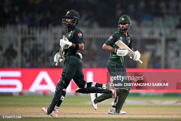 Pakistan's Fakhar Zaman and Abdullah Shafique run between the wickets during the 2023 ICC Men's Cricket World Cup one-day international match between...