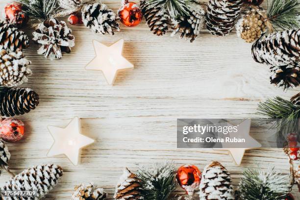 star tealight candles among spruce branches with cones and berries on white wooden surface with space for text. - tealight stock pictures, royalty-free photos & images