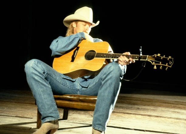 American country music artist Alan Jackson sings during his 1994 music video "I Don't Even Know Your Name", directed by Piers Plowden, circa 1994.