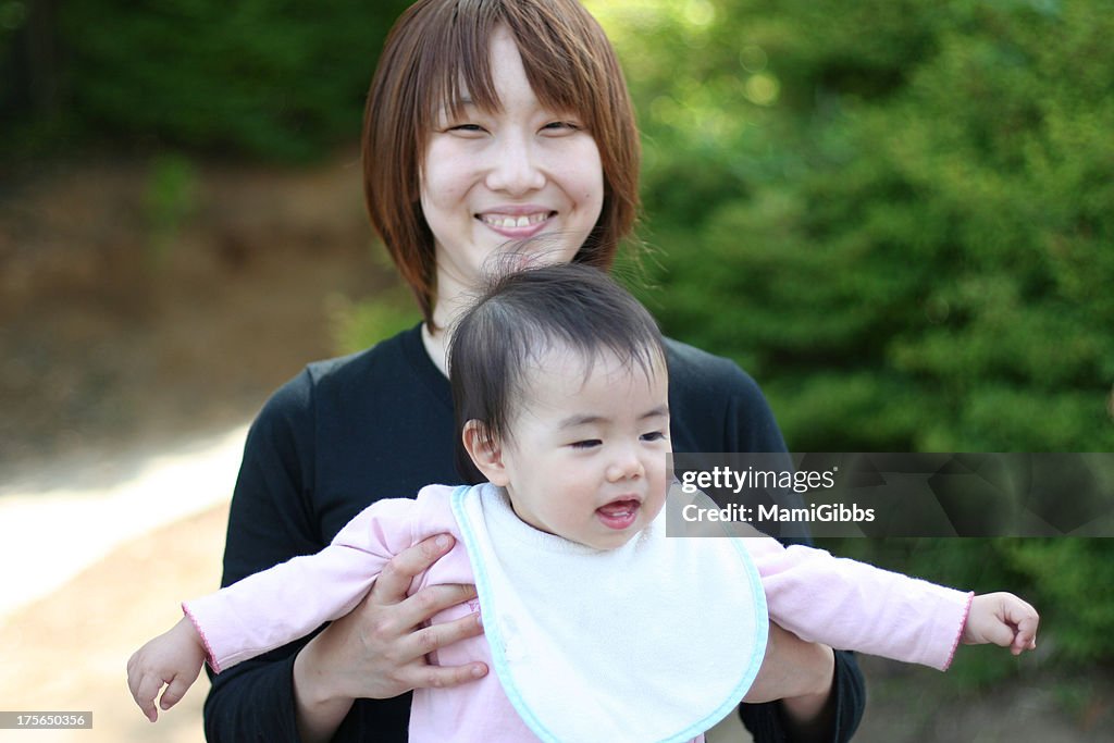 Mother hugging her baby at the park