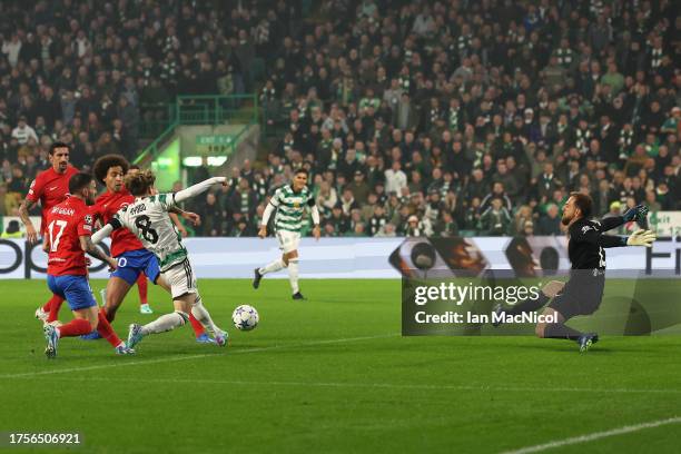 Kyogo Furuhashi of Celtic scores the team's first goal during the UEFA Champions League match between Celtic FC and Atletico Madrid at Celtic Park...