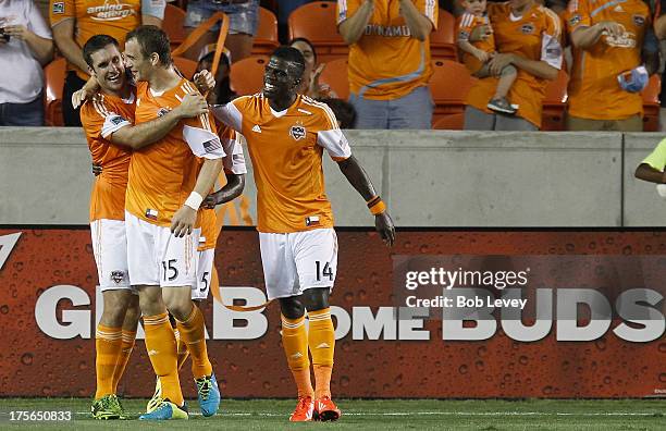 Cam Weaver of Houston Dynamo celebrates with Warren Creavalle of Houston Dynamo and Will Bruin after scoring in the second half against the Columbus...