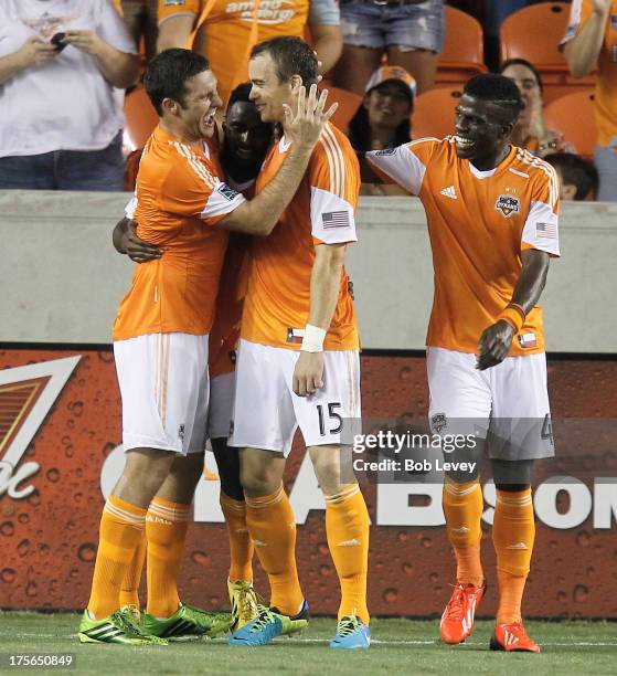 Cam Weaver, Warren Creavalle and Will Bruin of Houston Dynamo celebrate after scoring in the second half against the Columbus Crew at BBVA Compass...
