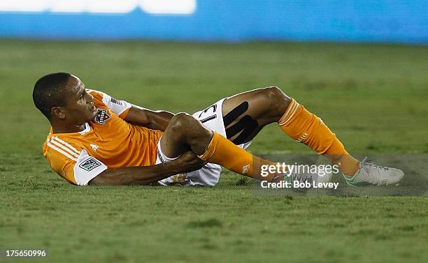 Ricardo Clark of Houston Dynamo holds his right leg after being injured in the first half against the Columbus Crew at BBVA Compass Stadium on August...