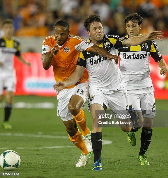 Ricardo Clark of Houston Dynamo holds off Danny O'Rourke of Columbus Crew as he goes for the ball at BBVA Compass Stadium on August 3, 2013 in...