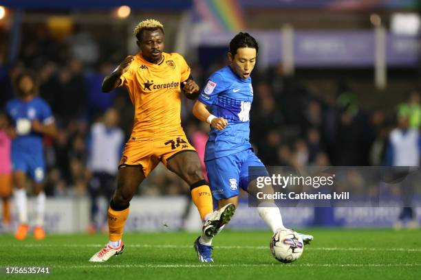 Jean Michael Seri of Hull City challenges Koji Miyoshi of Birmingham City during the Sky Bet Championship match between Birmingham City and Hull City...