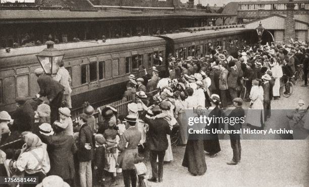 Draft of men board the train in Hounslow, England en route for the front, which in 1914 was Belgium. From The Pageant of the Century, published 1934.