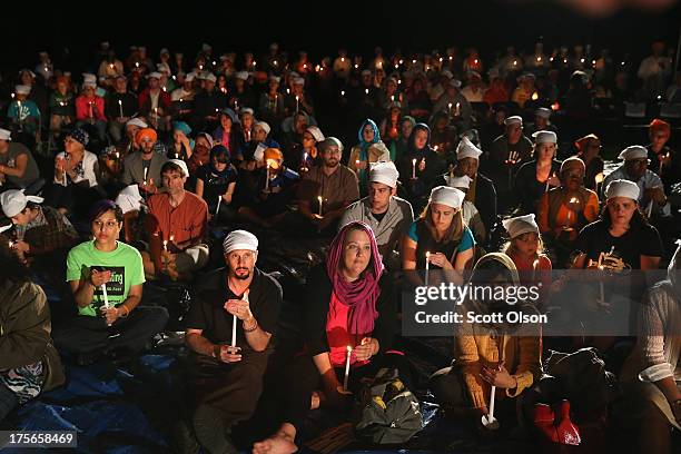 Community members attend a vigil at the Sikh Temple of Wisconsin to mark the one-year anniversary of the shooting at the temple August 5, 2013 in Oak...