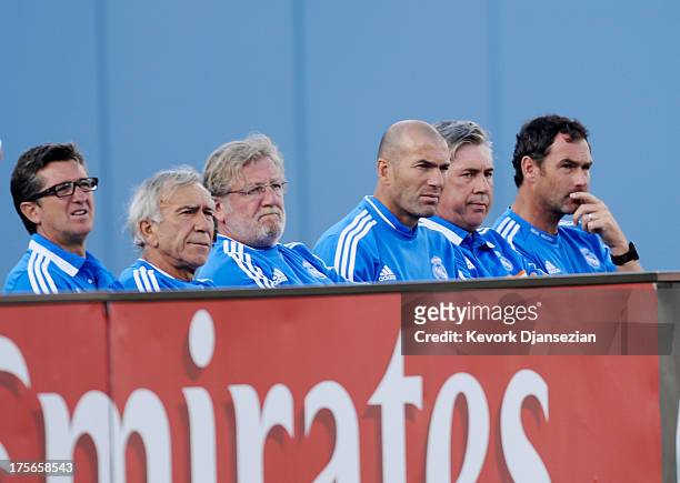 Manager Carlo Ancelotti of Real Madrid, assistant coach Zinedine Zidane and the rest of the coaching staff during the second half of 2013 Guinness...