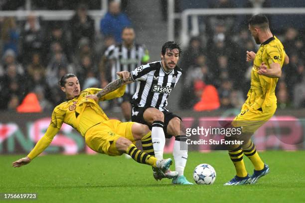 Sandro Tonali of Newcastle United is challenged by Marcel Sabitzer of Borussia Dortmund during the UEFA Champions League match between Newcastle...