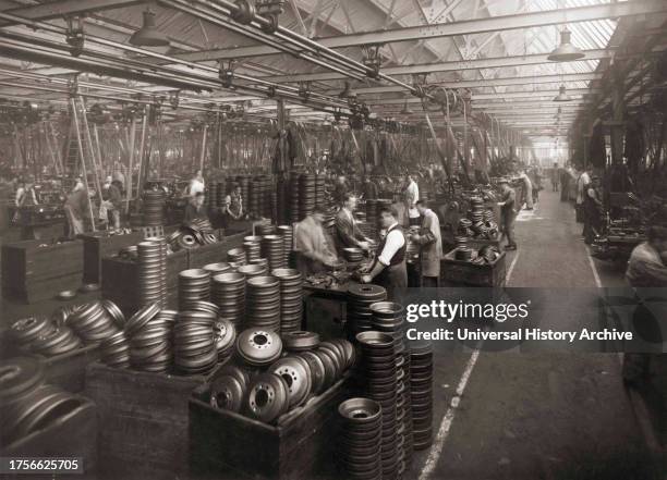 Interior of Wolseley Motors near Birmingham in the 1930's. Workers preparing hubcaps. .