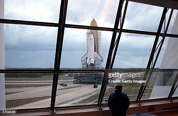 View from inside the Launch Control Center shows Space Shuttle Columbia rolling to Launch Pad 39A, sitting atop the Mobile Launcher Platform, which...