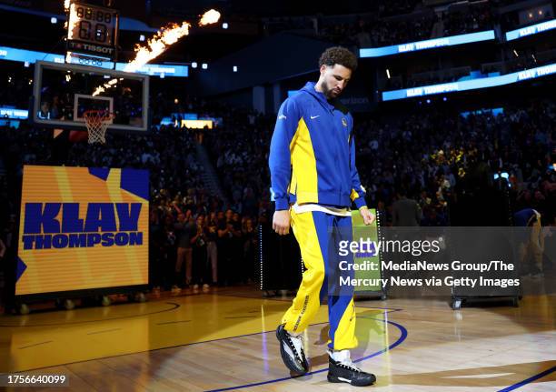 Golden State Warriors' Klay Thompson walks the court during the introduction of players before the season opener tip off against the Phoenix Suns at...