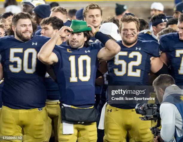 Notre Dame Fighting Irish quarterback Sam Hartman celebrates with his teammates after the college football game between the Pittsburgh Panthers and...