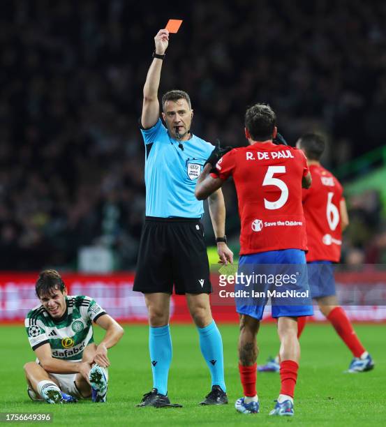 Rodrigo De Paul of Atletico Madrid is shown a red card by Referee Felix Zwayer after receiving a second yellow card during the UEFA Champions League...