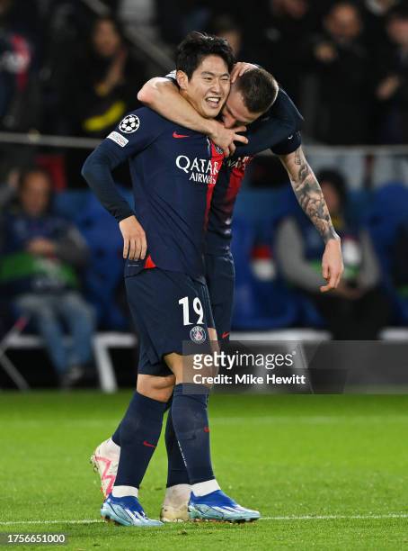 Lee Kang-In of Paris Saint-Germain celebrates with Milan Skriniar of Paris Saint-Germain after scoring the team's third goal during the UEFA...