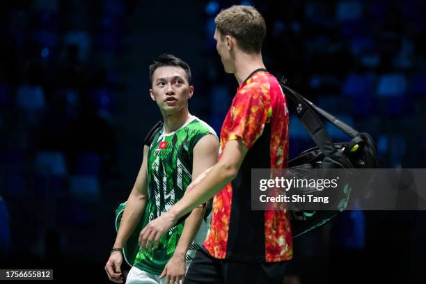 Ng Ka Long Angus of Hong Kong walks off the court as Viktor Axelsen of Denmark being forced to retire due to injury in the Men's Singles First Round...