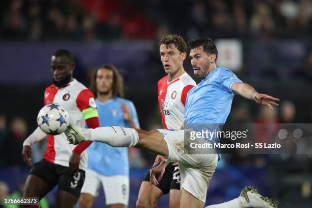 Alessio Romagnoli of SS Lazio competes for the ball with Mats Wieffer of Feyenoord during the UEFA Champions League Group E match between Feyenoord...