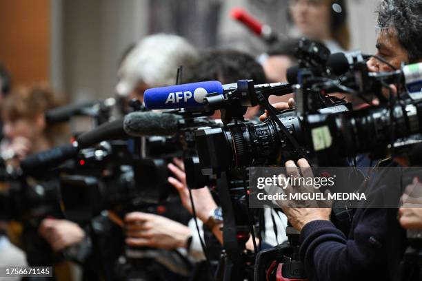 This photograph shows the Agence France-Presse logo, on the microphone of a camera, held by a video journalist, during a press conference, in Paris,...