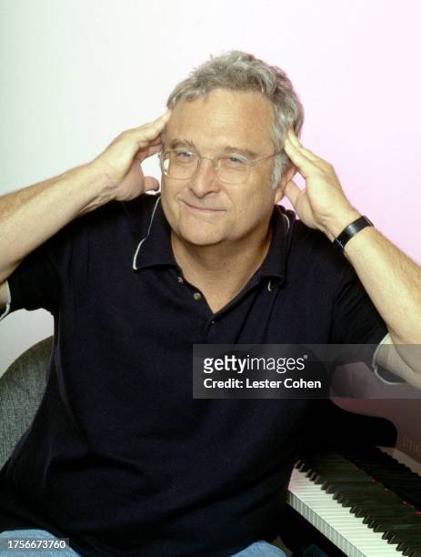 American singer Randy Newman poses for a portrait next to his piano at his home in Los Angeles, California, circa 1994.