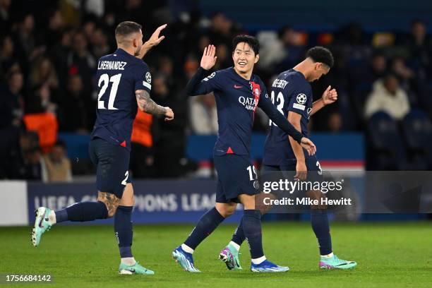 Lee Kang-In of Paris Saint-Germain celebrates with Lucas Hernandez and Warren Zaire-Emery of Paris Saint-Germain after scoring the team's third goal...